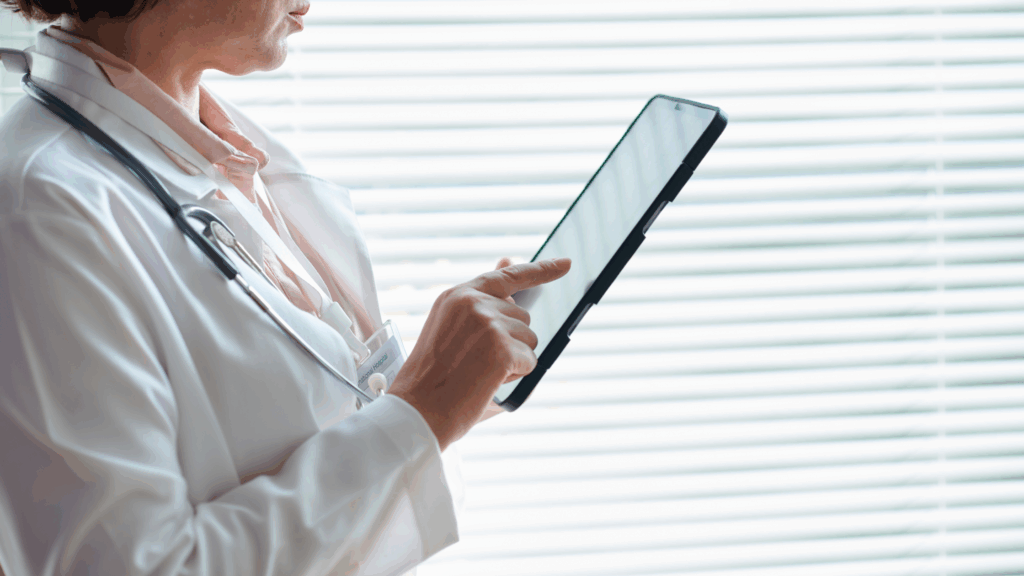 Surgeon reviewing perioperative communication updates on a tablet